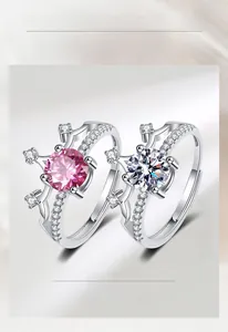 Detailed macro view of silver crown rings with pink and white moissanite stones