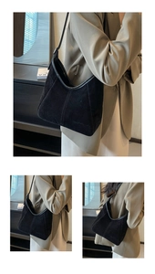 Detail of black matte suede hobo bag featuring smooth leather trims and shoulder strap