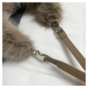 Close-up of khaki plush faux fur bag with leather strap and silver metal buckle detail