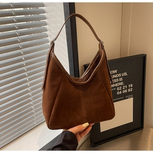 Detailed view of the dark brown suede hobo bag with smooth leather trim for commuting