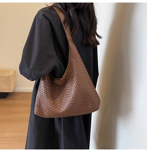 Detail of caramel brown woven texture on large shoulder tote bag for women