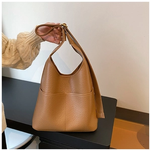Close-up of brown litchi pattern leather tote bag with functional front pocket