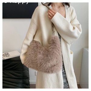 Close-up of a plush coffee faux fur shoulder bag with leather strap and metal buckle
