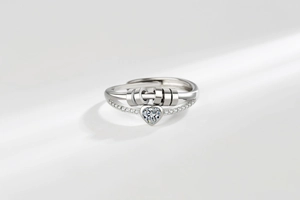 Close-up of heart-shaped diamond ring with double-row micro-pave and movable silver bead