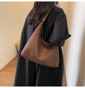 Detail of brown woven faux leather hobo bag showing texture and large capacity