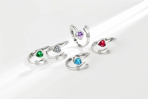 Detailed macro of S925 sterling silver heart rings with hugging hands design and engravings