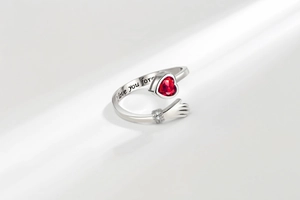 Macro detail of 'I love you forever' engraving on the silver embrace hug ring band