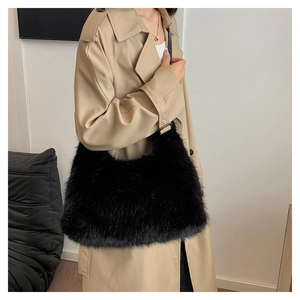 Detail of black fluffy faux fur shoulder bag worn with a chic beige trench coat