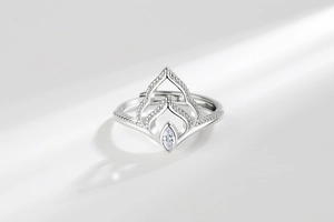 Detailed macro of a silver crown ring featuring a marquise-cut zircon and beaded edges