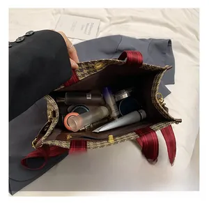 Interior view of large capacity tote bag showing spacious storage for cosmetics and purse