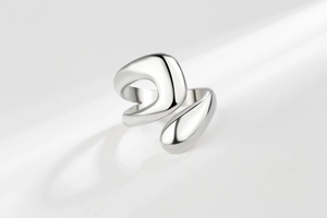 Detailed view of irregular polished silver ring with a fluid mirror-like finish