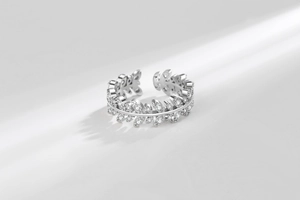 Macro shot of silver leaf ring with pavé zircons and adjustable open band design