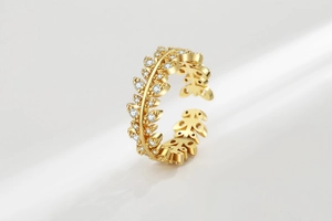 Detailed view of adjustable golden leaf ring featuring sparkling white zircon stones