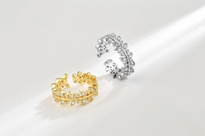 Macro detail of adjustable leaf rings in gold and silver finish with zircon inlay
