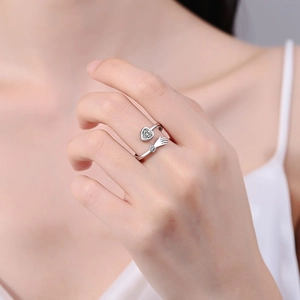Silver adjustable hug ring with heart cubic zirconia and hand shaped diamond accents
