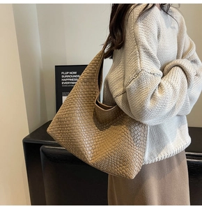 Close-up of brown woven leather texture on a spacious hobo tote bag for daily commute