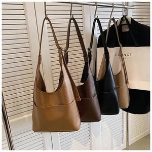 Close-up of four minimalist large tote bags in brown, coffee, black and khaki colors