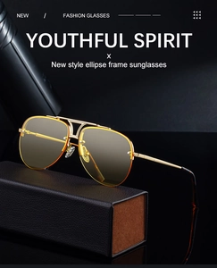 Detail of pilot sunglasses with gold metal frame and gradient lenses next to leather case