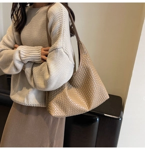 Detail shot of khaki woven hobo shoulder bag texture and fine synthetic leather craftsmanship