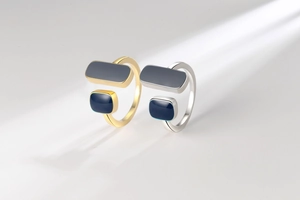 Detail view of gold and silver minimalist open rings with deep blue geometric stones