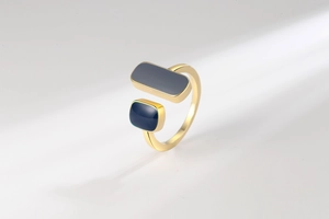 Macro detail of gold open ring featuring two elegant dark blue enamel rectangles