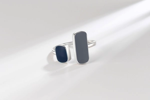 Detailed close-up of adjustable minimalist ring with blue enamel geometric elements