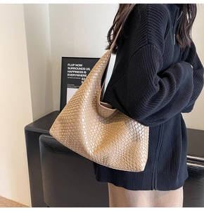 Detail of the intricate leather weave pattern on the beige large capacity hobo tote bag