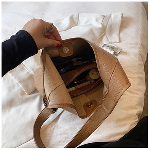 Close-up of brown litchi pattern tote bag showing spacious interior with zipper pocket