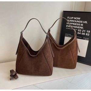 Detailed view of coffee brown suede hobo tote bags with soft matte texture and straps