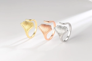 Detailed view of adjustable ginkgo leaf rings in gold, rose gold and silver finishes