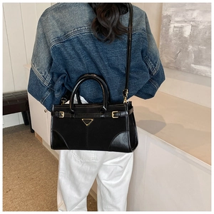 Black vintage wax leather tote bag shown on a model for a stylish commuting look