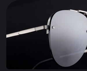 Detailed macro view of metal hinge and rivets on silver pilot sunglasses frame