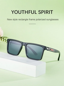 Detail of square polarized sunglasses with metallic hinges and red accents on white podium