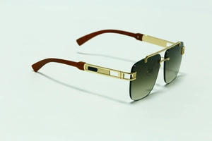 Detail of square rimless sunglasses with gold metal frame and brown wood grain temples