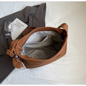 Internal view of the brown leather tote showing spacious lining and zipper pocket