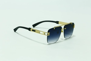 Detailed close-up of golden metal frame with elegant hollow carving on blue gradient sunglasses