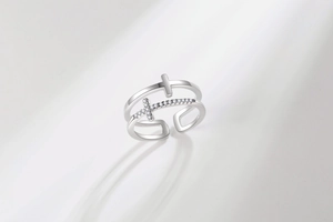Macro shot of silver double-layered cross ring with sparkling zircon stone setting