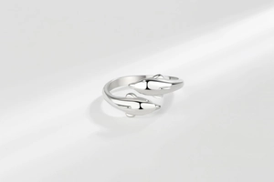 Detail of silver dolphin open ring featuring sparkling zircon eyes and mirror finish