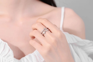 Detail of double-layer cross ring with pave-set cubic zirconia on female finger
