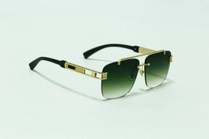 Detail of luxury rimless sunglasses with gold metal frame and carved wood grain legs