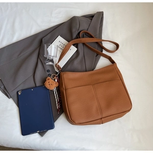 Brown faux leather tote with dual front pockets and a cute bear keychain ornament