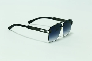 Detail of square rimless sunglasses with blue gradient lenses and textured metal temples