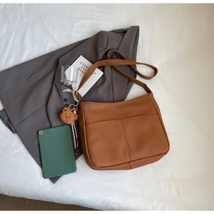 Brown lychee grain leather hobo bag with teddy bear pendant and vintage texture