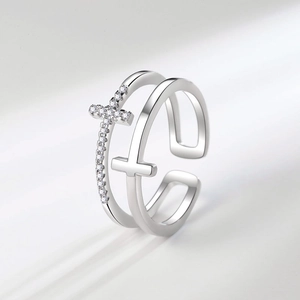 Double layered cross ring with sparkling crystals in an open adjustable silver design