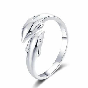 Polished silver double dolphin open ring with white zircon eyes on white background