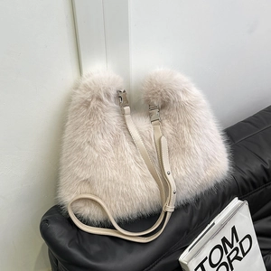 Furry minimalist shoulder bag in cream faux fur with leather strap on black seat