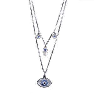 Close-up of double-layer necklace with Hamsa hand and blue Evil Eye crystal pendants