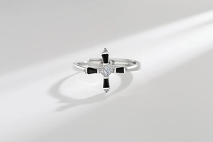 Detailed shot of adjustable silver cross ring with square zircon and black enamel finish