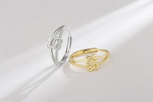 Detail of twisted cable rings in gold and silver with double heart knot design