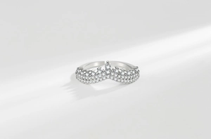 Detailed view of silver crown V-shaped ring with pavé-set sparkling cubic zirconia